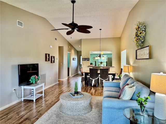 4452 Weybridge St Unit 74, Sarasota, FL 34235 - living area featuring wood finished floors, ceiling fan, a textured ceiling, and high vaulted ceiling