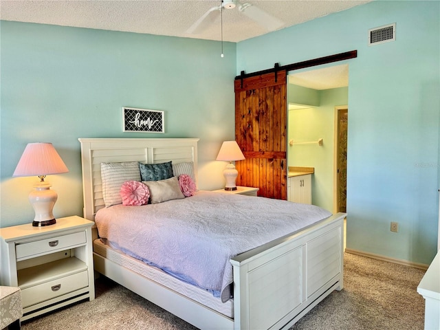 4452 Weybridge St Unit 74, Sarasota, FL 34235 - bedroom with carpet, a barn door, and a textured ceiling