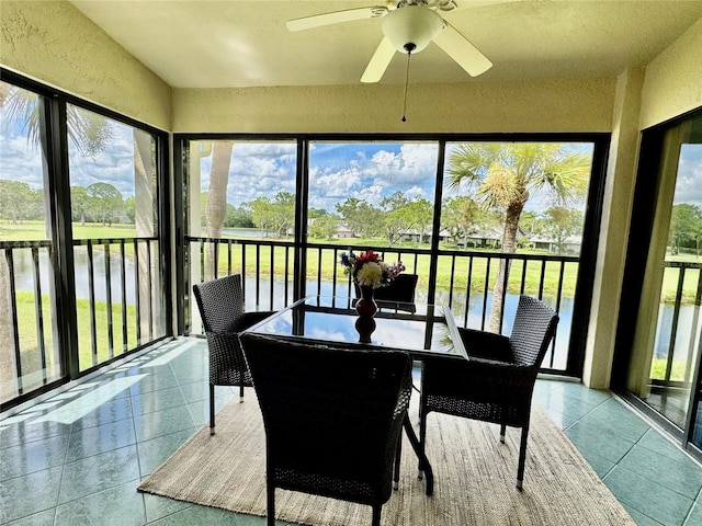 4452 Weybridge St Unit 74, Sarasota, FL 34235 - sunroom featuring ceiling fan, a textured wall, tile patterned flooring, and a water view