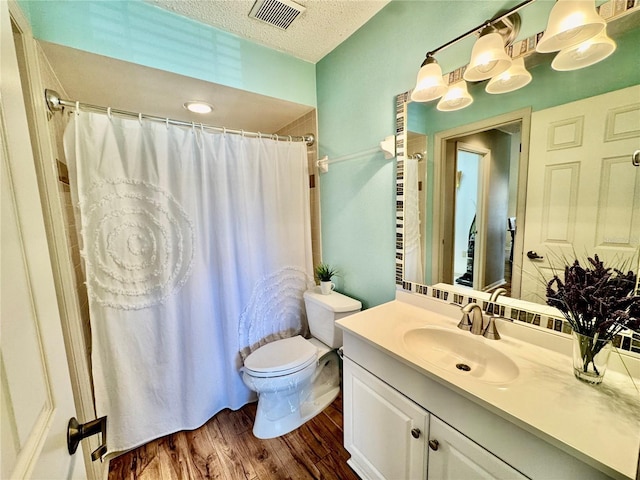 4452 Weybridge St Unit 74, Sarasota, FL 34235 - full bathroom with vanity, wood finished floors, a textured ceiling, and curtained shower