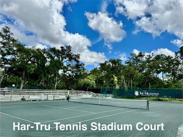 4452 Weybridge St Unit 74, Sarasota, FL 34235 - view of tennis court featuring view of wooded area