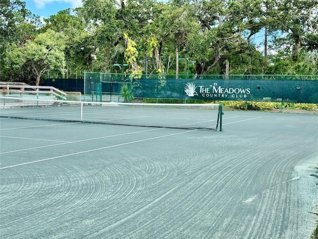 4452 Weybridge St Unit 74, Sarasota, FL 34235 - view of tennis court featuring view of wooded area