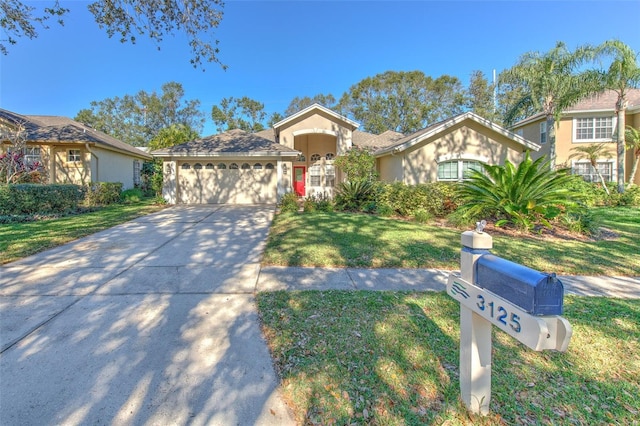 view of front of property featuring a garage and a front yard