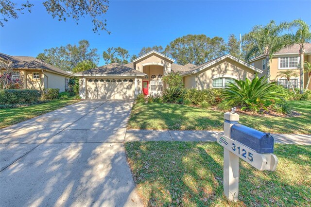 3125 Bent Creek Dr, Valrico, FL 33596 - view of front facade with a garage, a front lawn, driveway, and stucco siding