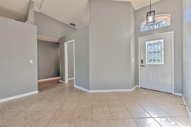 tiled entrance foyer with high vaulted ceiling