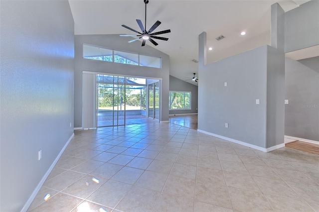 empty room featuring ceiling fan, high vaulted ceiling, and light tile patterned floors