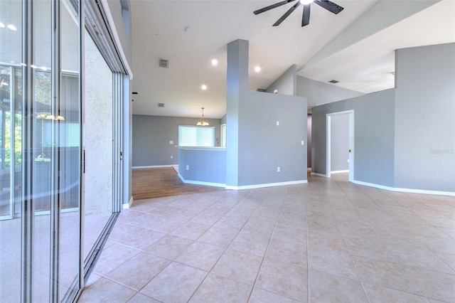 unfurnished living room featuring ceiling fan with notable chandelier, high vaulted ceiling, and light tile patterned flooring