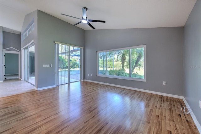 empty room with vaulted ceiling, light hardwood / wood-style flooring, and ceiling fan