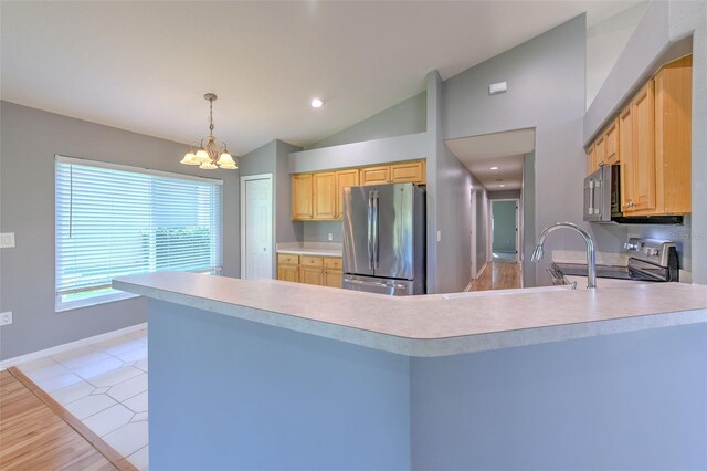 3125 Bent Creek Dr, Valrico, FL 33596 - kitchen featuring appliances with stainless steel finishes, lofted ceiling, a chandelier, light countertops, and a peninsula