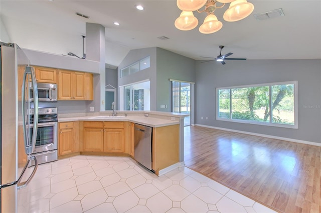 kitchen with sink, stainless steel appliances, light hardwood / wood-style flooring, kitchen peninsula, and ceiling fan with notable chandelier