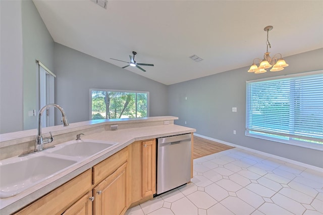 kitchen with light brown cabinets, sink, hanging light fixtures, vaulted ceiling, and stainless steel dishwasher