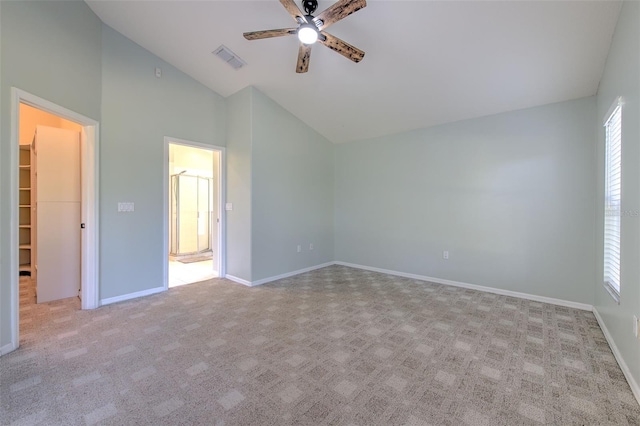 unfurnished bedroom with light colored carpet, a walk in closet, and multiple windows