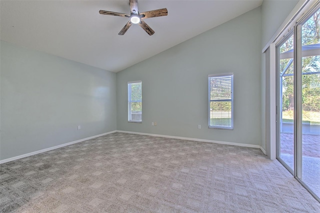 spare room featuring light carpet, ceiling fan, and vaulted ceiling