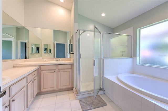 bathroom with tile patterned floors, vanity, and plus walk in shower