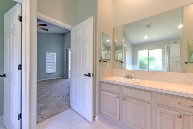 bathroom with tile patterned flooring, ceiling fan, an enclosed shower, and vanity