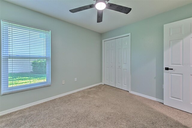 3125 Bent Creek Dr, Valrico, FL 33596 - unfurnished bedroom featuring light colored carpet, a closet, baseboards, and ceiling fan