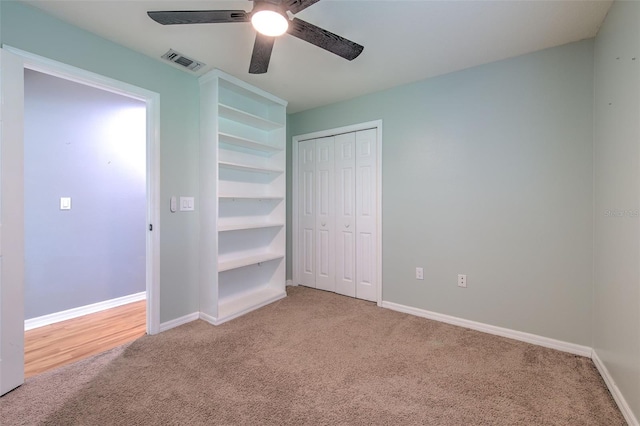 unfurnished bedroom with carpet, ceiling fan, and a closet