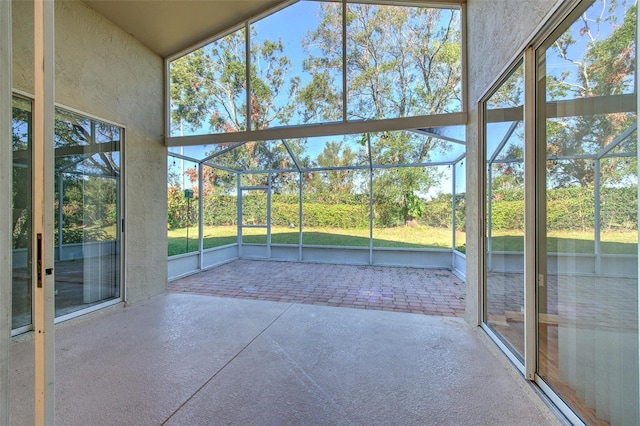 unfurnished sunroom featuring vaulted ceiling