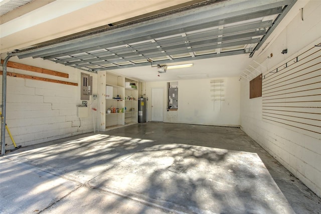 garage featuring a garage door opener, electric water heater, and electric panel