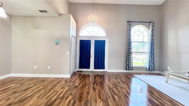 2012 Fern Ridge Ct, Holiday, FL 34691 - foyer entrance with wood finished floors, a chandelier, and baseboards