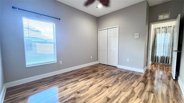 2012 Fern Ridge Ct, Holiday, FL 34691 - unfurnished bedroom featuring wood finished floors, a closet, baseboards, and ceiling fan