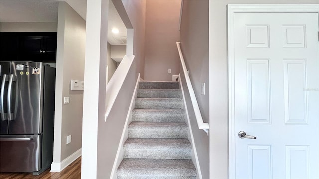 2012 Fern Ridge Ct, Holiday, FL 34691 - staircase featuring baseboards and wood finished floors