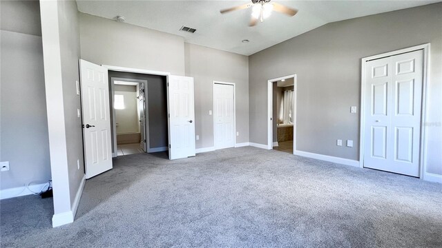 2012 Fern Ridge Ct, Holiday, FL 34691 - unfurnished bedroom featuring carpet flooring, vaulted ceiling, baseboards, ensuite bathroom, and multiple closets