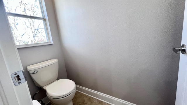 2012 Fern Ridge Ct, Holiday, FL 34691 - bathroom featuring toilet, tile patterned floors, and baseboards