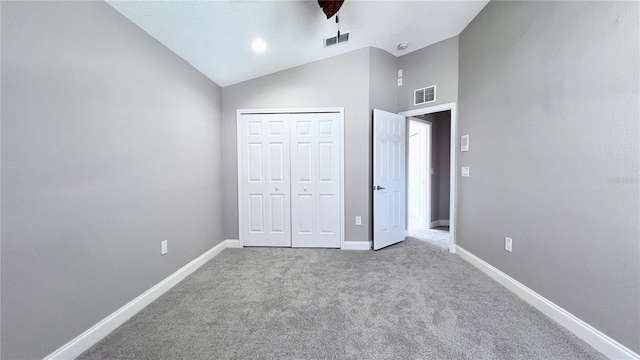 2012 Fern Ridge Ct, Holiday, FL 34691 - unfurnished bedroom featuring carpet, baseboards, lofted ceiling, a closet, and a ceiling fan