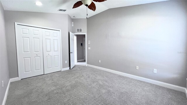 2012 Fern Ridge Ct, Holiday, FL 34691 - unfurnished bedroom featuring carpet, a closet, baseboards, vaulted ceiling, and ceiling fan