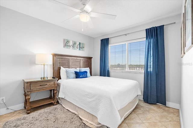 tiled bedroom featuring ceiling fan