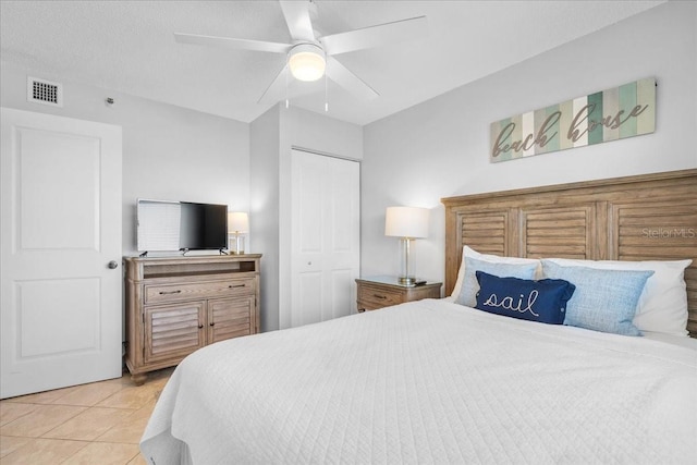 tiled bedroom featuring a closet and ceiling fan