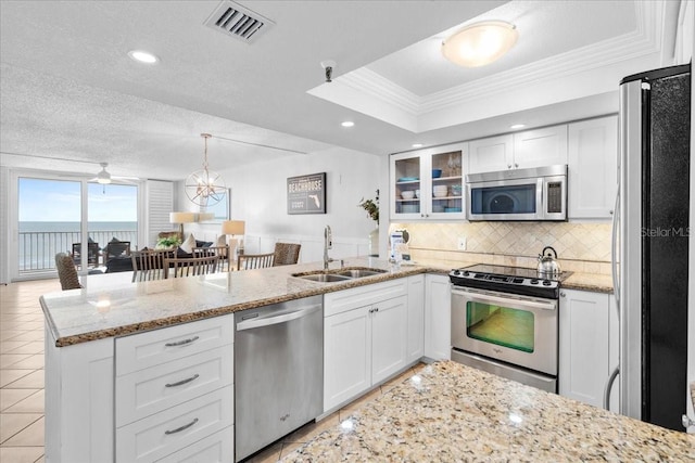 kitchen featuring a textured ceiling, stainless steel appliances, crown molding, sink, and white cabinets