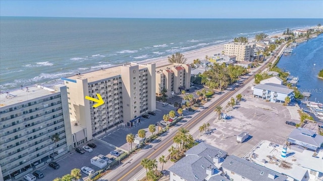 birds eye view of property featuring a water view and a beach view