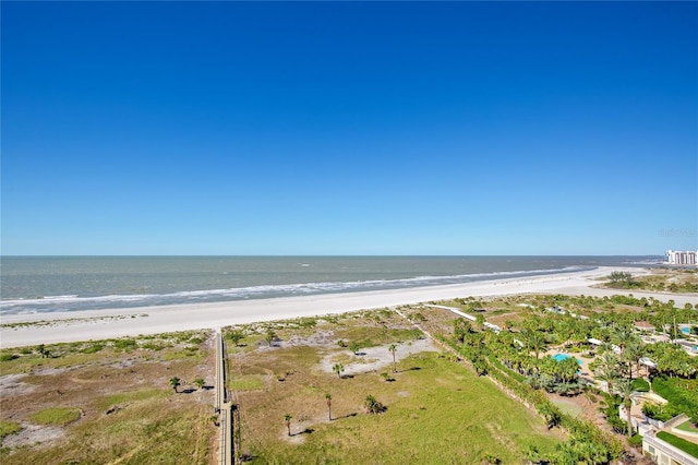 bird's eye view with a water view and a beach view