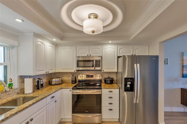 kitchen featuring light stone countertops, white cabinets, and appliances with stainless steel finishes