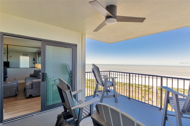 balcony featuring ceiling fan and a water view