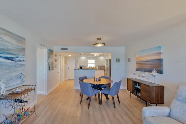 dining area with light hardwood / wood-style flooring