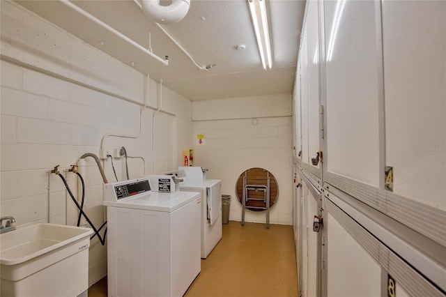 laundry room featuring sink and washing machine and clothes dryer