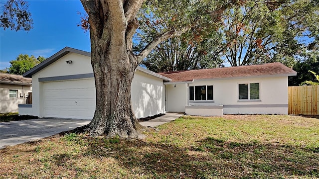 single story home featuring a front yard and a garage