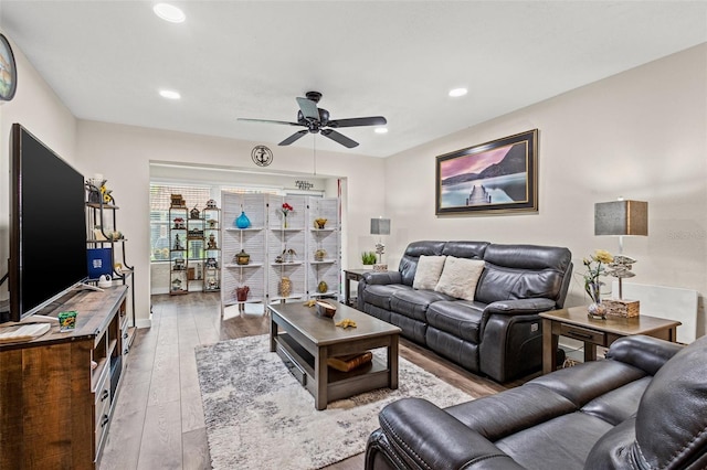 living room with ceiling fan and light hardwood / wood-style floors