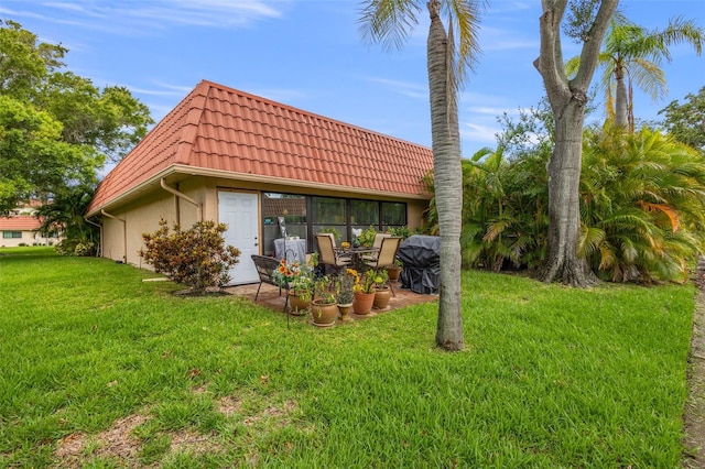 rear view of house with a yard