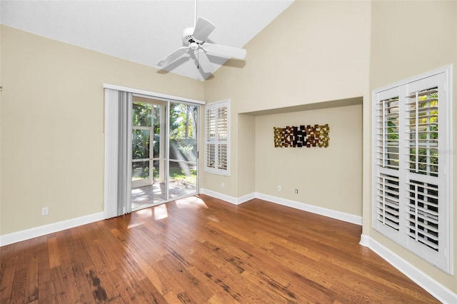 unfurnished room featuring hardwood / wood-style flooring, ceiling fan, and high vaulted ceiling