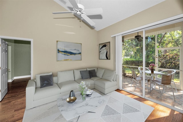 living room with plenty of natural light, high vaulted ceiling, and hardwood / wood-style floors