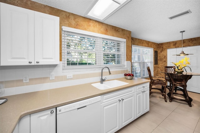 kitchen with white cabinets, dishwasher, sink, and hanging light fixtures