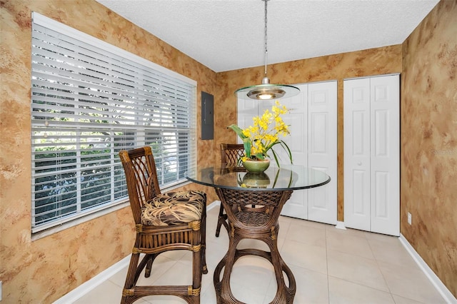 dining room featuring light tile patterned floors, a textured ceiling, electric panel, and a healthy amount of sunlight