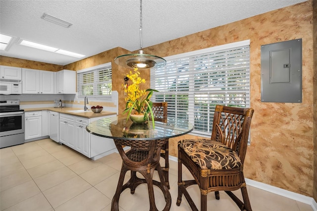 kitchen with sink, electric panel, a textured ceiling, white appliances, and white cabinets