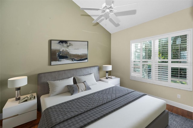 bedroom featuring dark hardwood / wood-style floors, vaulted ceiling, and ceiling fan