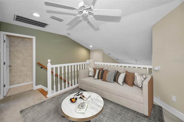 living room with ceiling fan, carpet floors, a textured ceiling, and vaulted ceiling