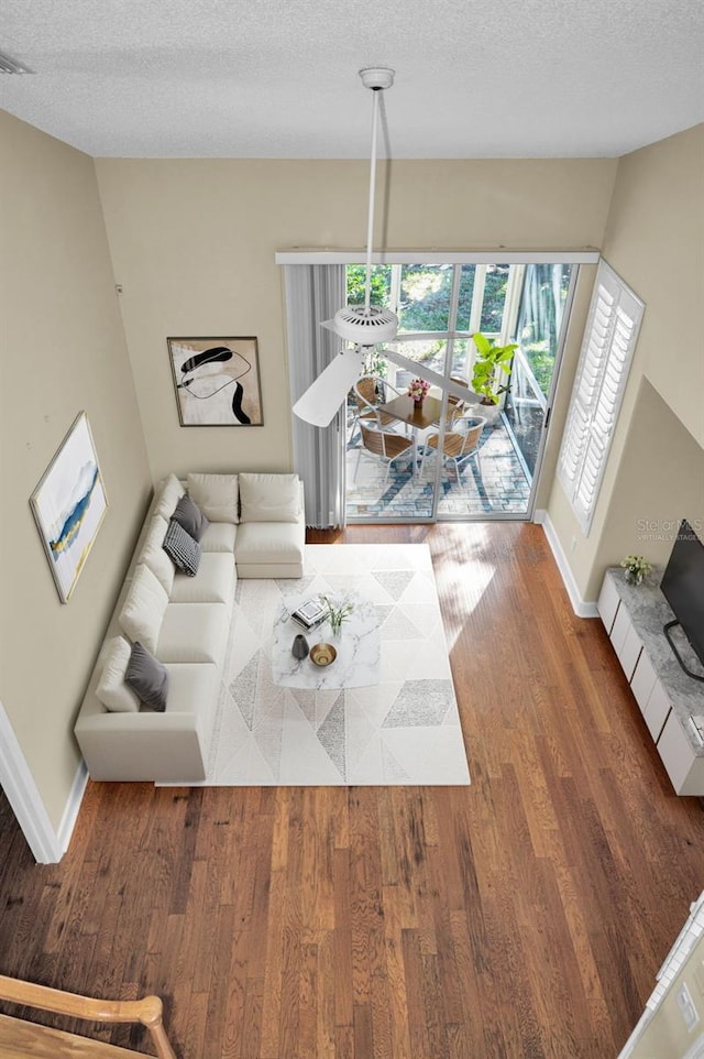 living room with hardwood / wood-style floors and a textured ceiling